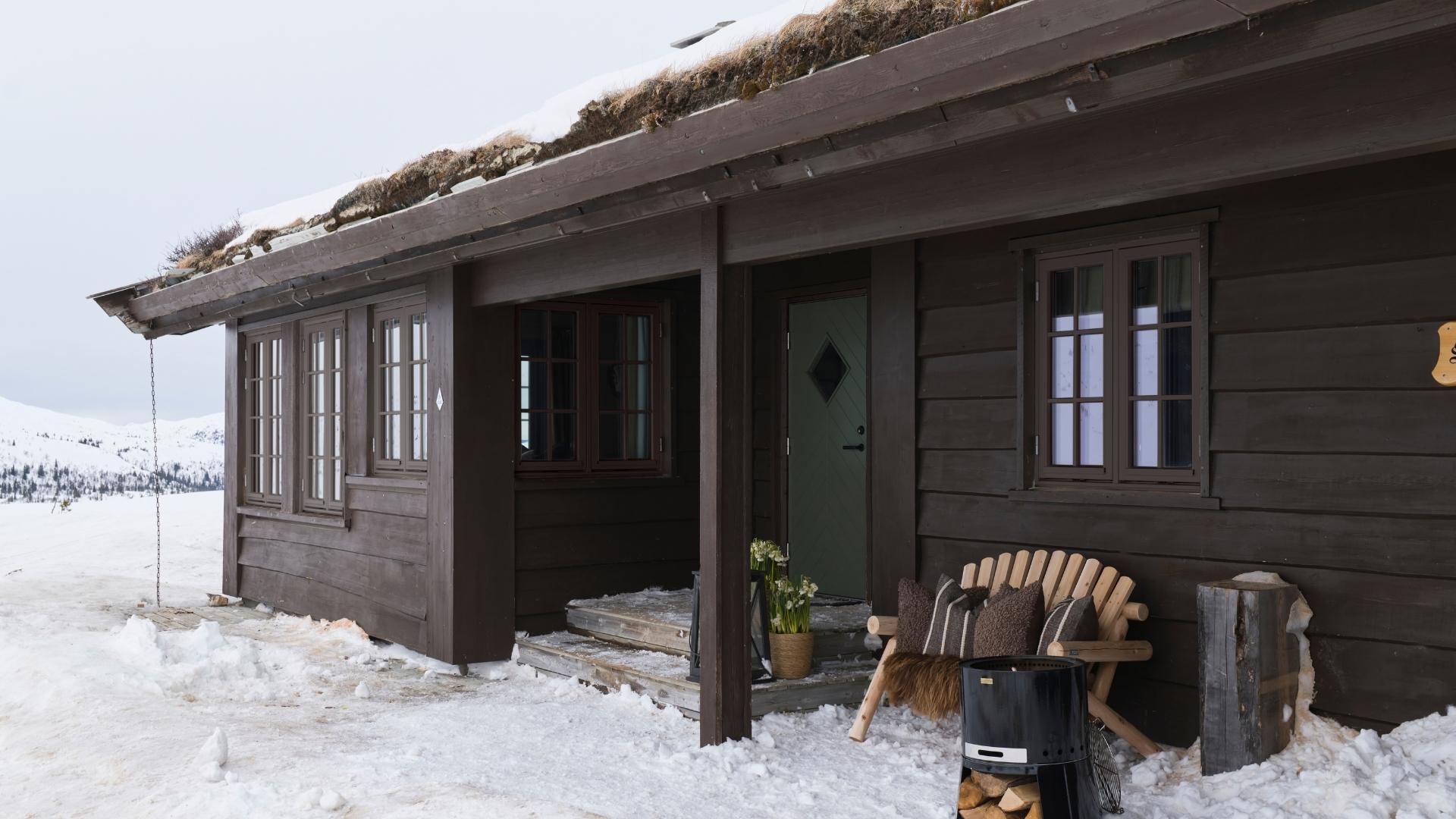 Cozy cabin in winter landscape.