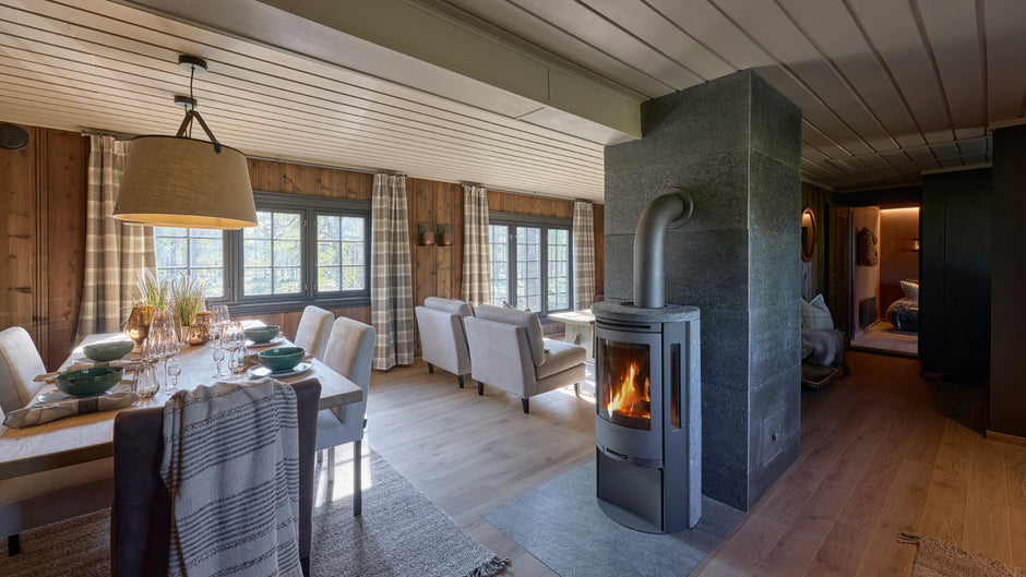 Cozy living room with a stone fireplace and wooden furniture.